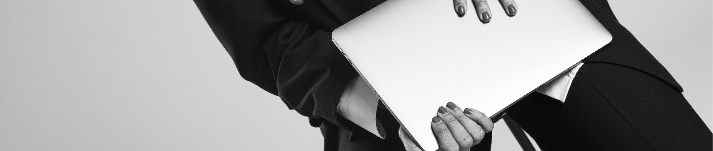 a close-up of a person holding a laptop